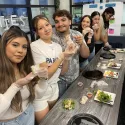 Students learning how to make spring rolls