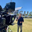 Alex Boylan TCT host presenting in front of CSUSB sign