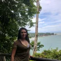 Student in front of cliffs and water