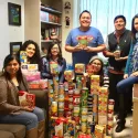 Club students in front of stacks of donated food