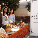 Club members at table with candy and cultural decor