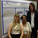 Group of people in front of poster 1