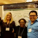 Group of people in front of poster 2
