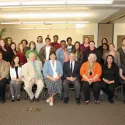 People sitting and standing for photo