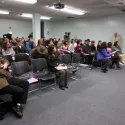 Group of people in room paying attention