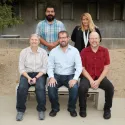 People sitting and standing for photo