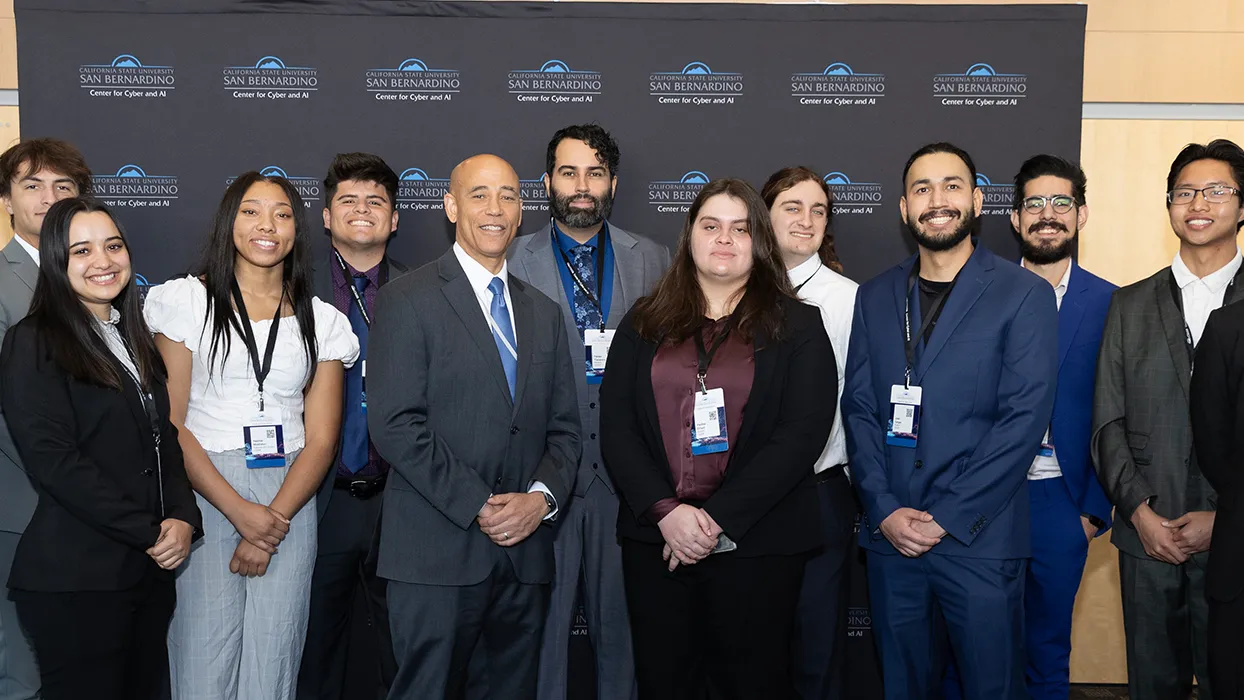 White House Deputy National Cyber Director Harry Wingo (front center with blue tie) posed with students from the Cyber Intelligence & Security Organization (CISO) and the Women in Cybersecurity (WiCyS) campus clubs.