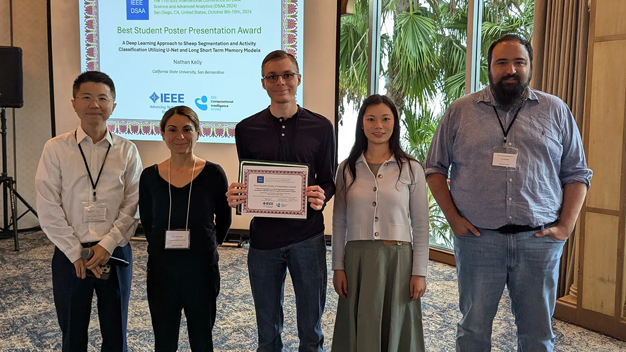 CSUSB student Nathan Kelly, center, was the recipient of the Best Student Poster Presentation Award at the 11th annual IEEE International Conference on Data Science and Advanced Analytics (DSAA) in San Diego.