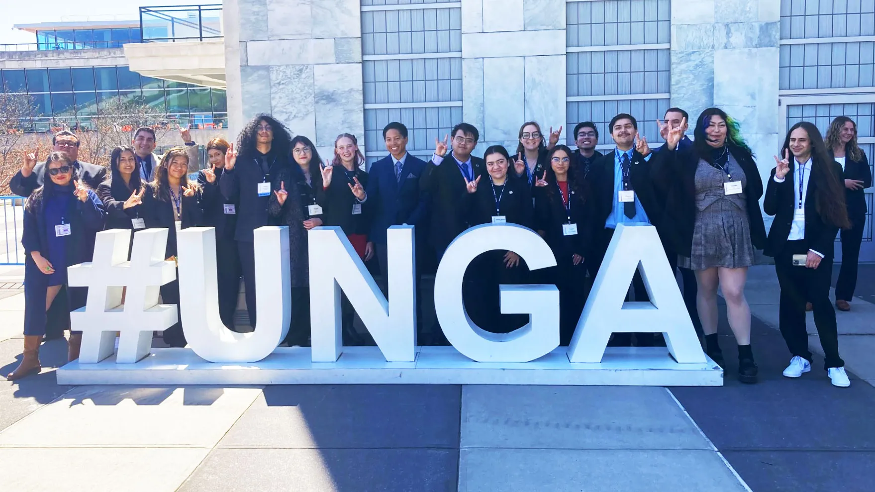The CSUSB Model United Nations team at the United Nations in New York, standing behind the #UNGA sign.
