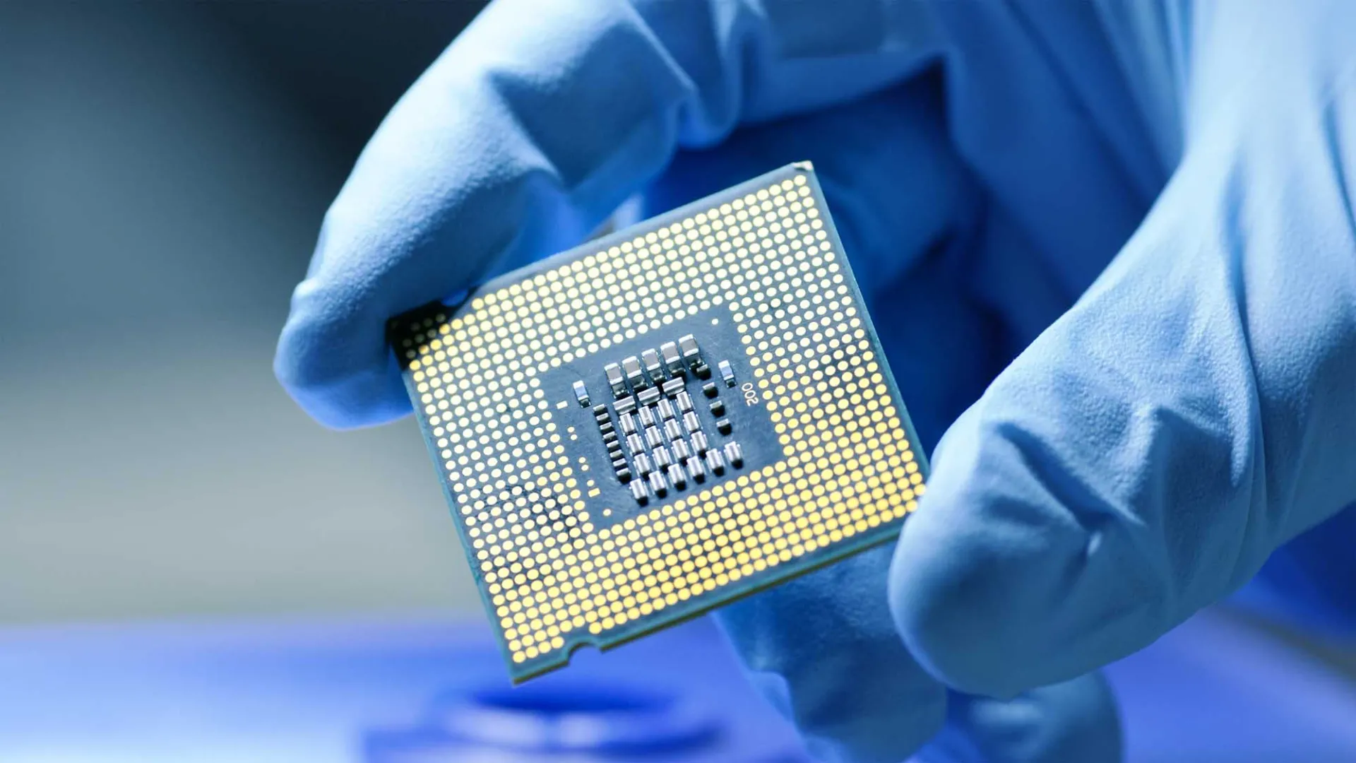A hand holding a computer chip