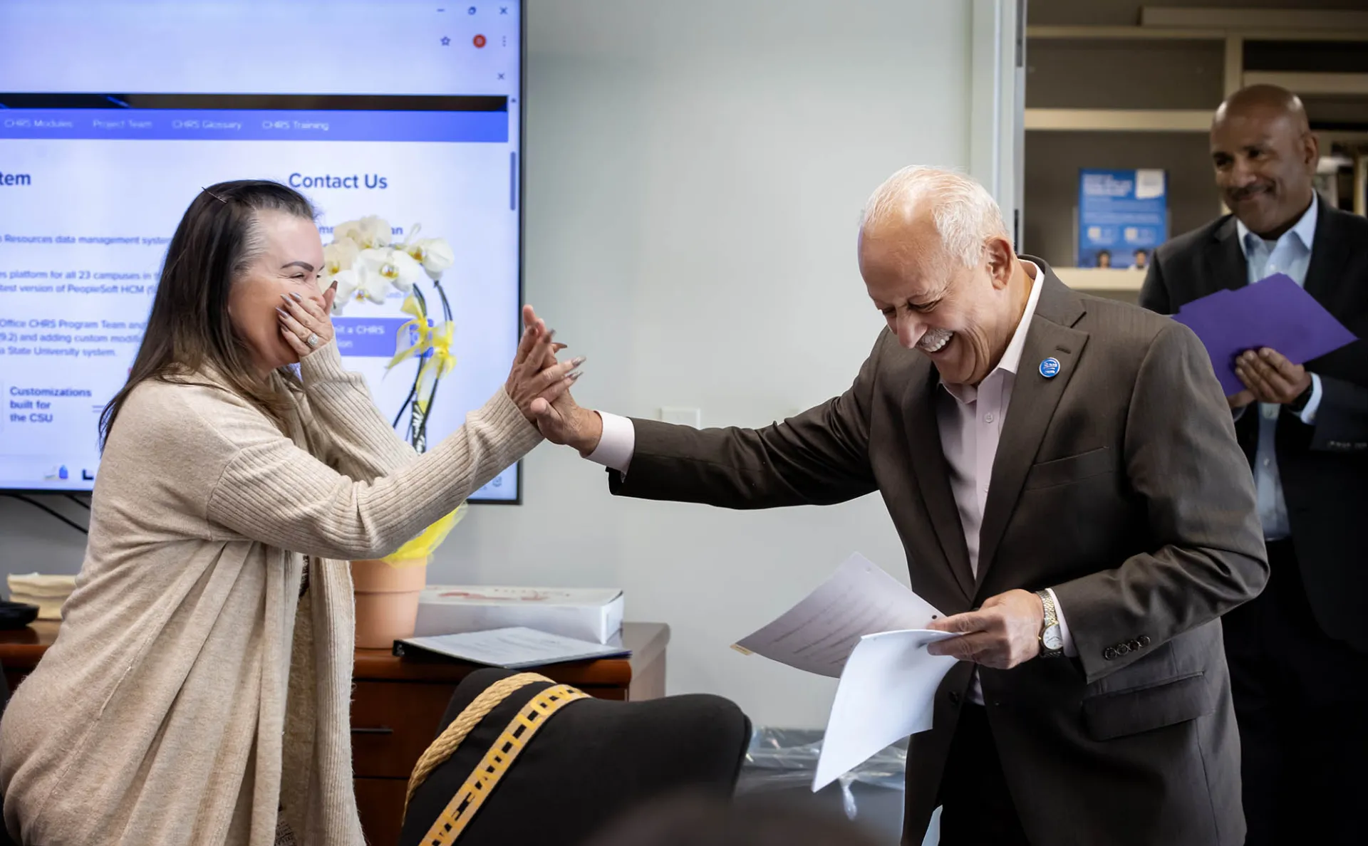 Rachel Estrada, left, and CSUSB President Tomás D. Morales exchange a high five as the president announces that she is the recipient of CSUSB’s 2024-25 Outstanding Lecturer Award.