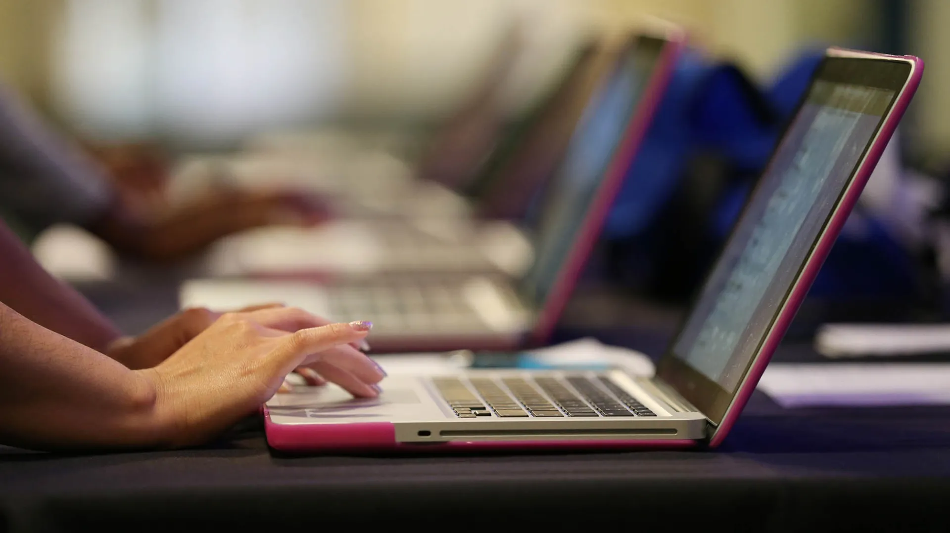Hands on a laptop keyboard.