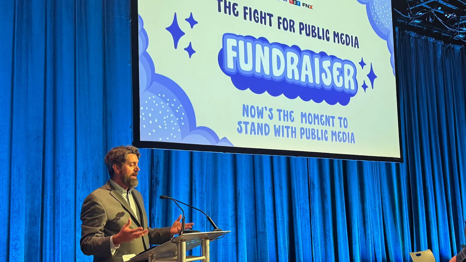 Thomas Corrigan, professor of communication and media, speaking at a recent fundraising event for the local public broadcasting station, KVCR.