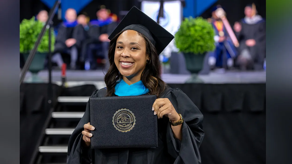 A graduate celebrating at CSUSB’s Jack H. Brown College of Business and Public Administration Commencement ceremony held last May. 
