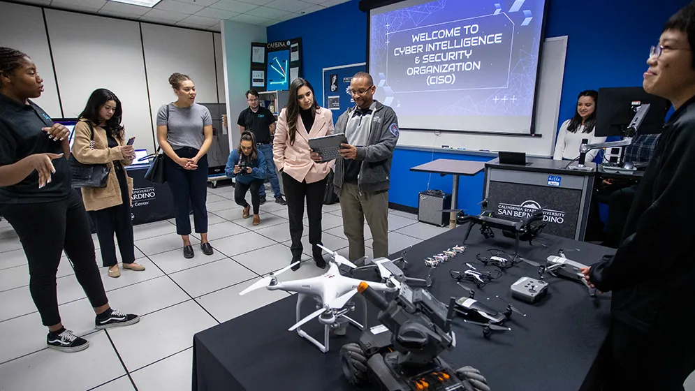 Student members of the Cyber Intelligencve & Security Organization (CISO) club present their cybersecurity projects to Sabrina Cervantes, (assemblymember of District 58).
