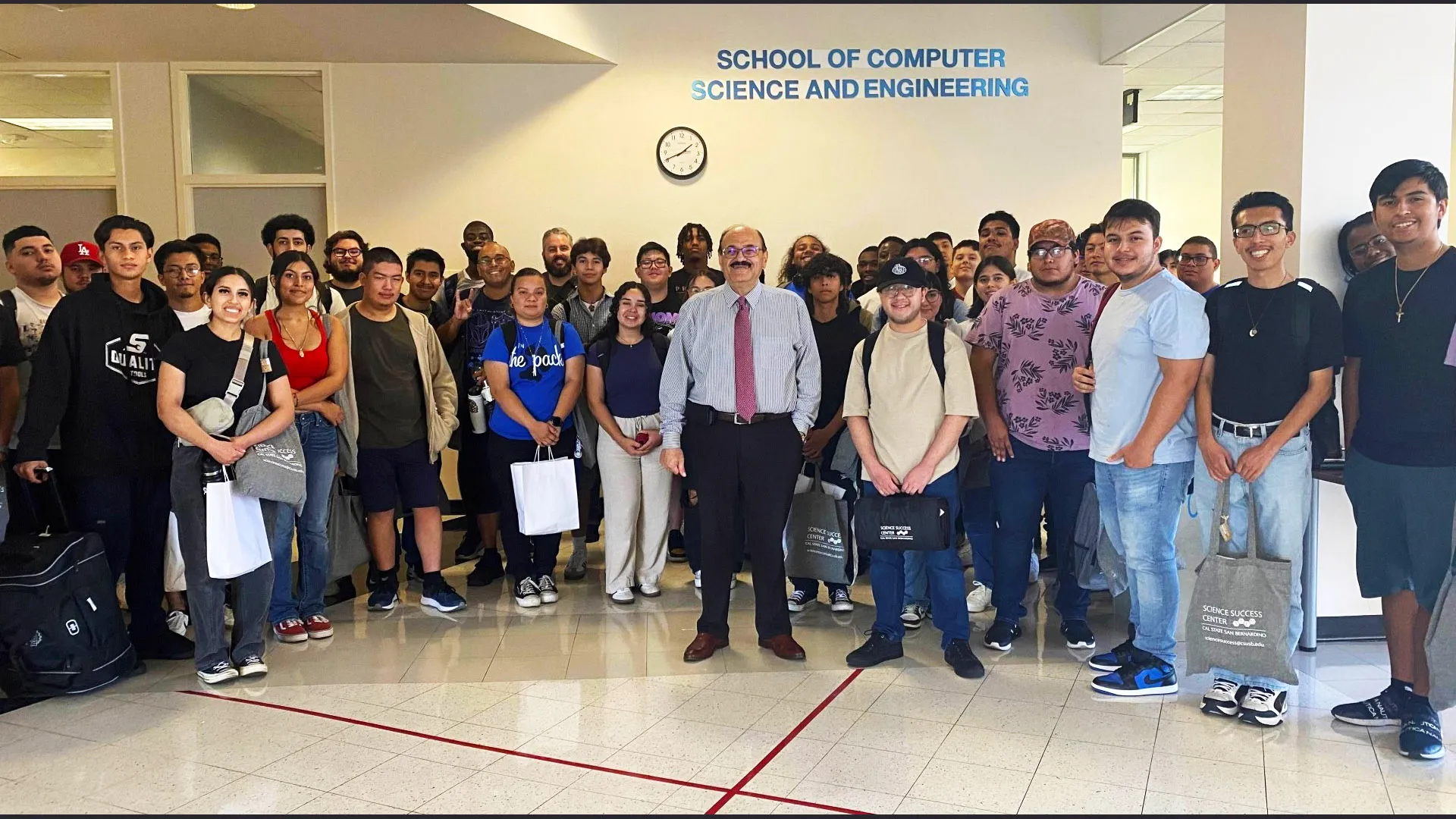 At the School of Computer Science and Engineering offices in the Jack H. Brown College building, Khalil Dajani, chair/director, at the center with students. The school had its ABET accreditation extended through 2032.