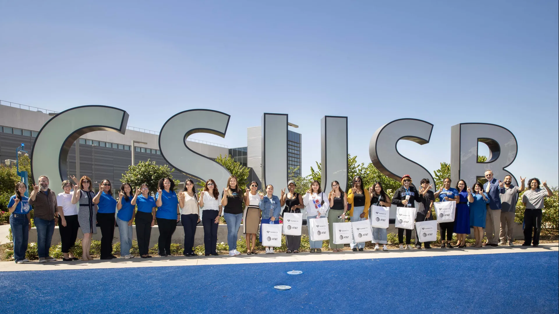 Group of people in front of the CSUSB spirit letters.