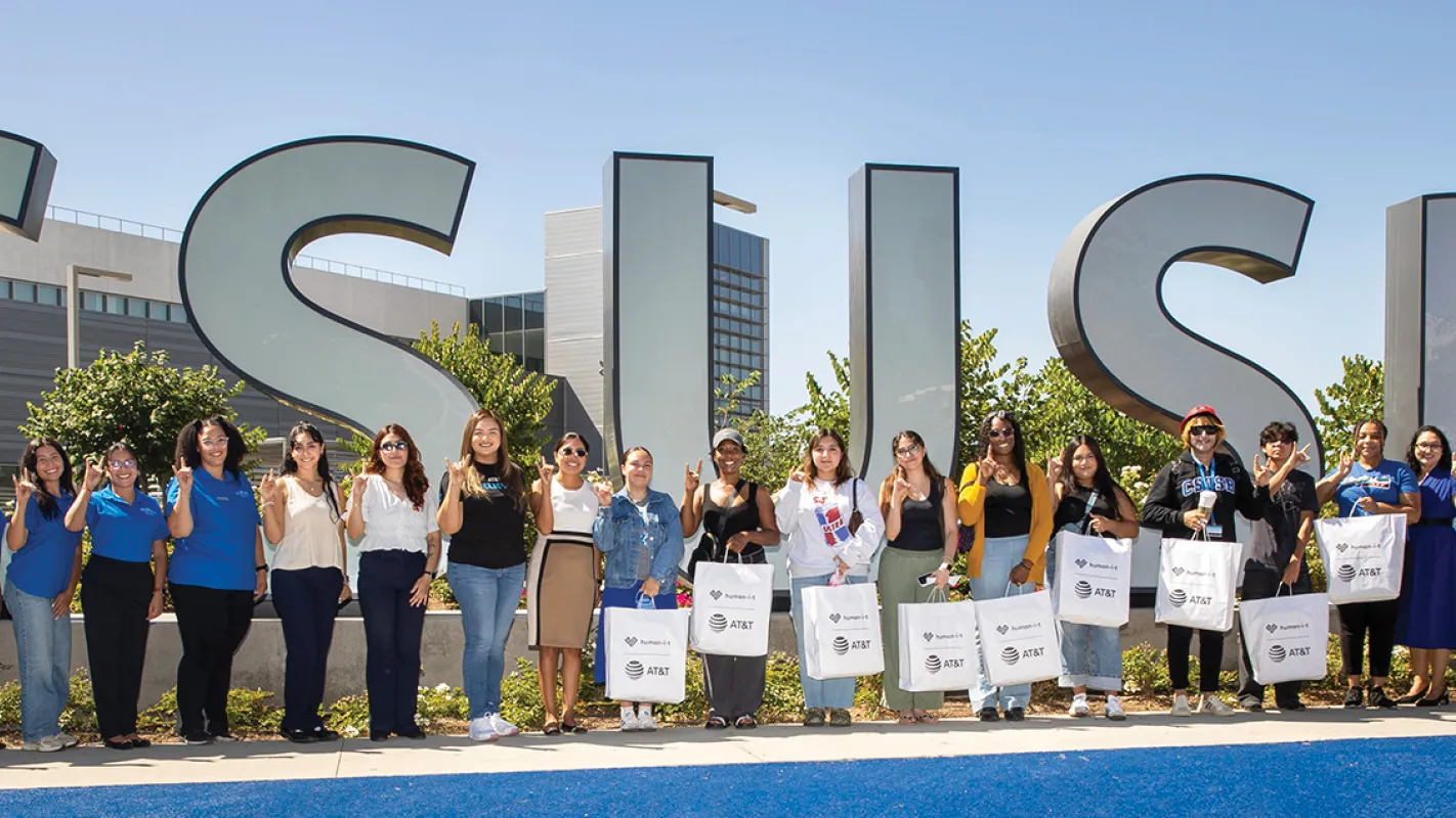 Group of people in front of the CSUSB spirit letters.