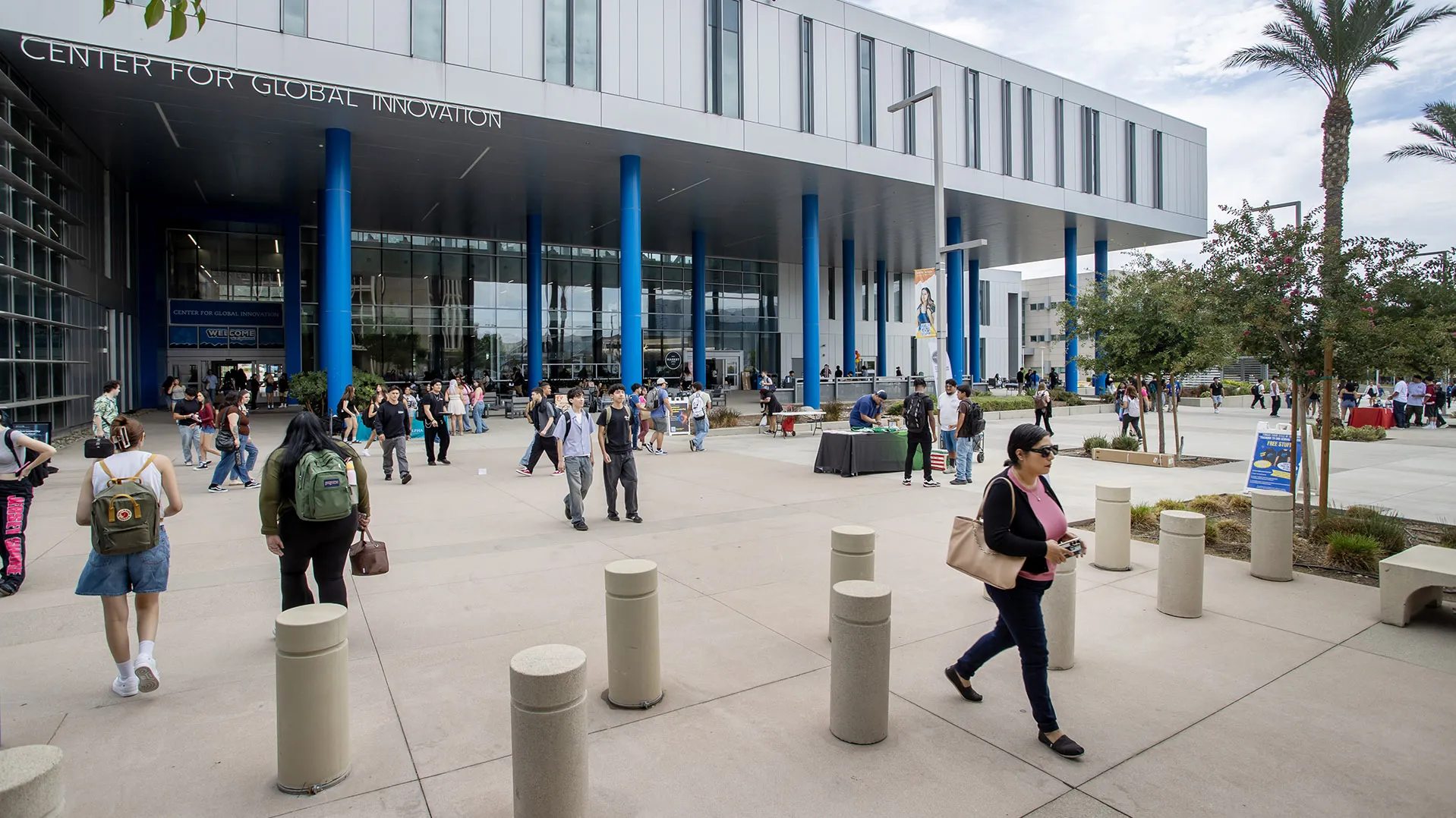 Students walking near the Center for Global Innovation building along Coyote Walk.