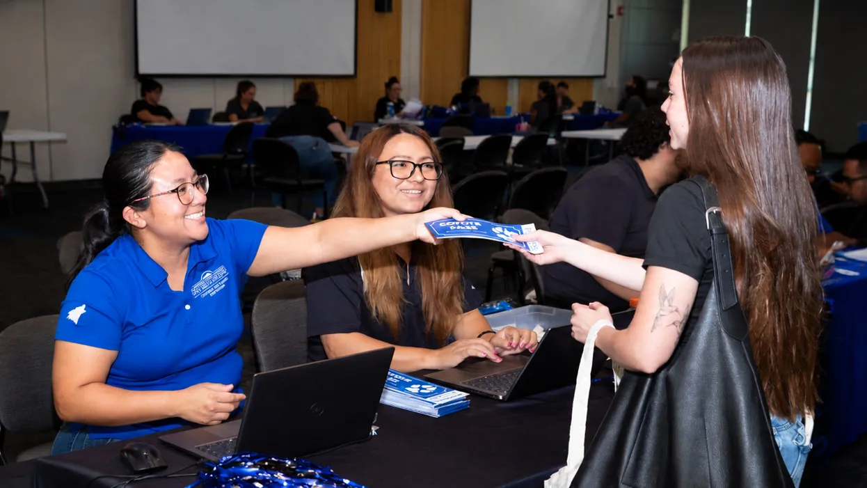 Photo of CSUSB admission counselors and a student. CSUSB in August held an Instant Admit Day at San Bernardino Valley College. NOTE: Photo was AI-enhanced (background edges) to fit the dimensions on this webpage.