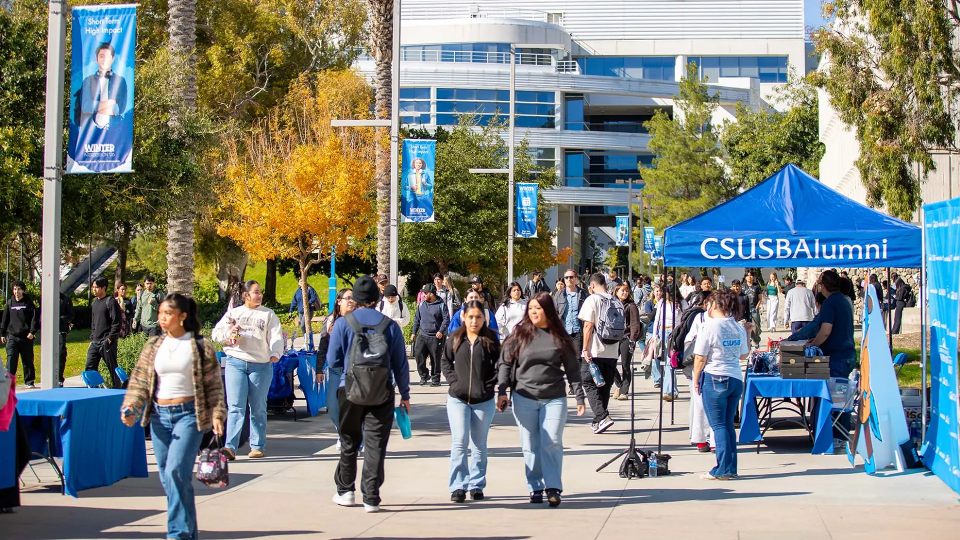 Students make their way along Coyote Walk at CSUSB. 