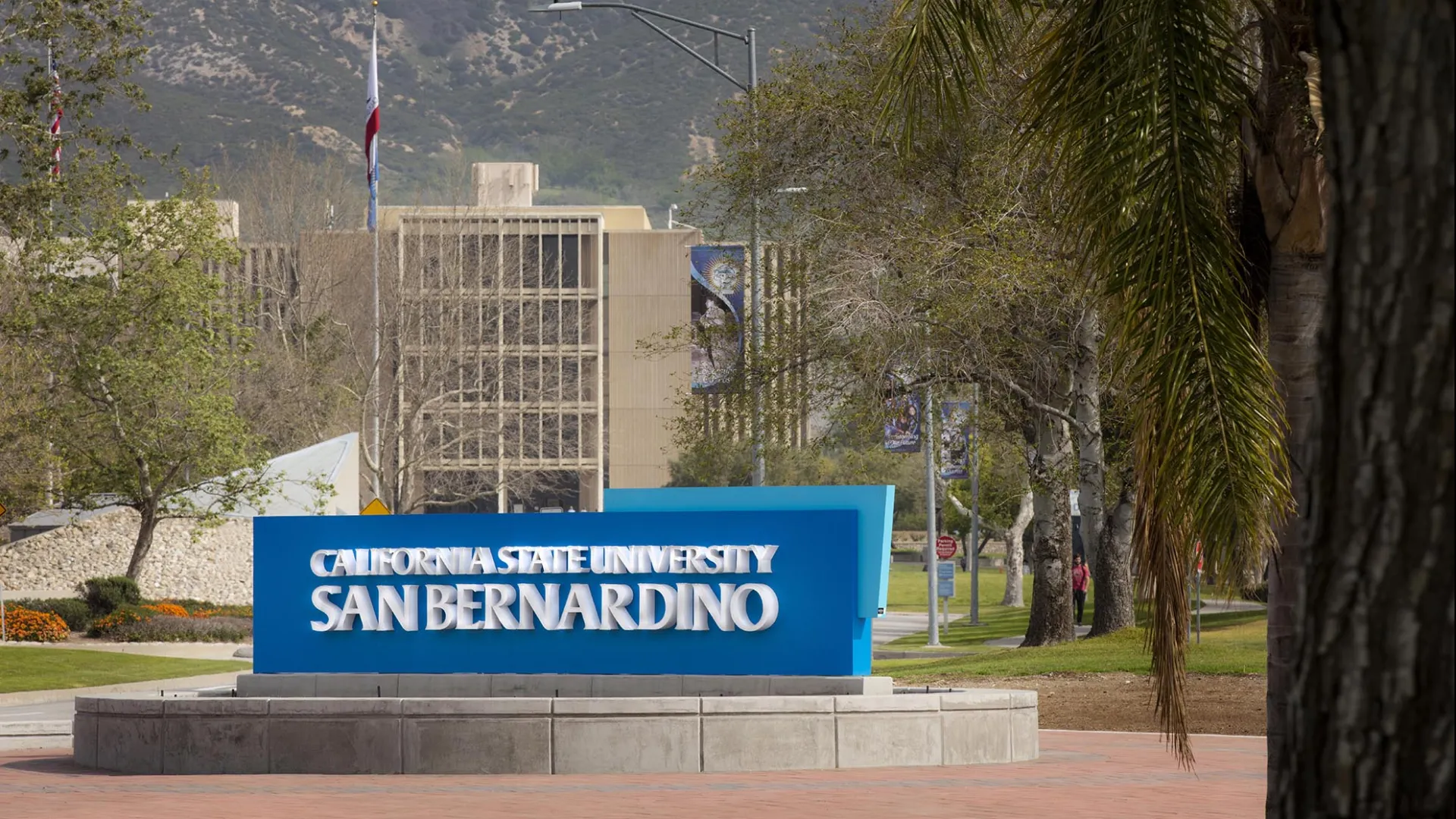 John M. Pfau Library and the California State University San Bernardino entrance sign on University Parkway.
