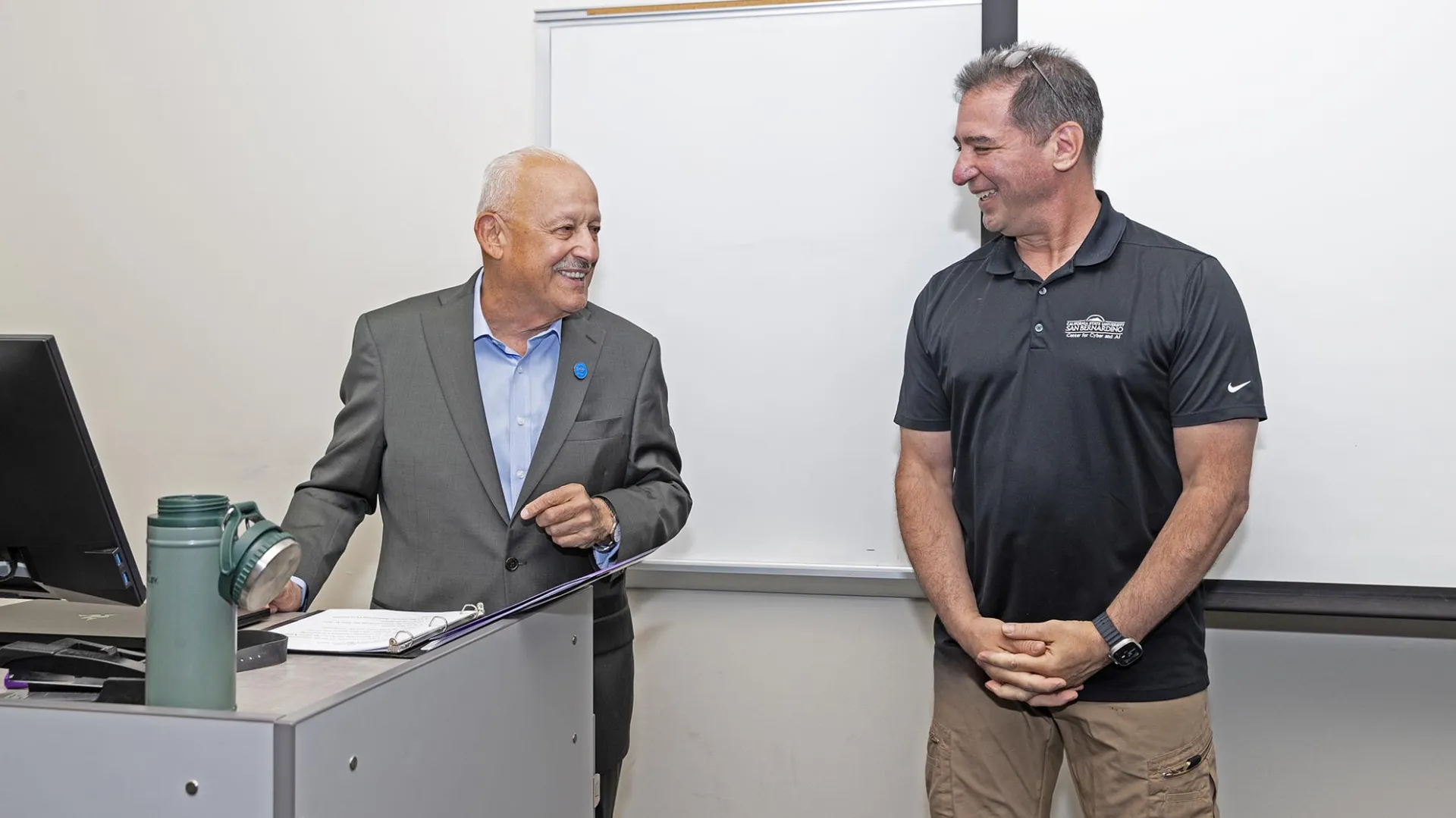 CSUSB President Tomás D. Morales (left) congratulates Vincent Nestler, professor in the School of Cyber and Decision Sciences and recipient of the 2026 Outstanding Professor Award.