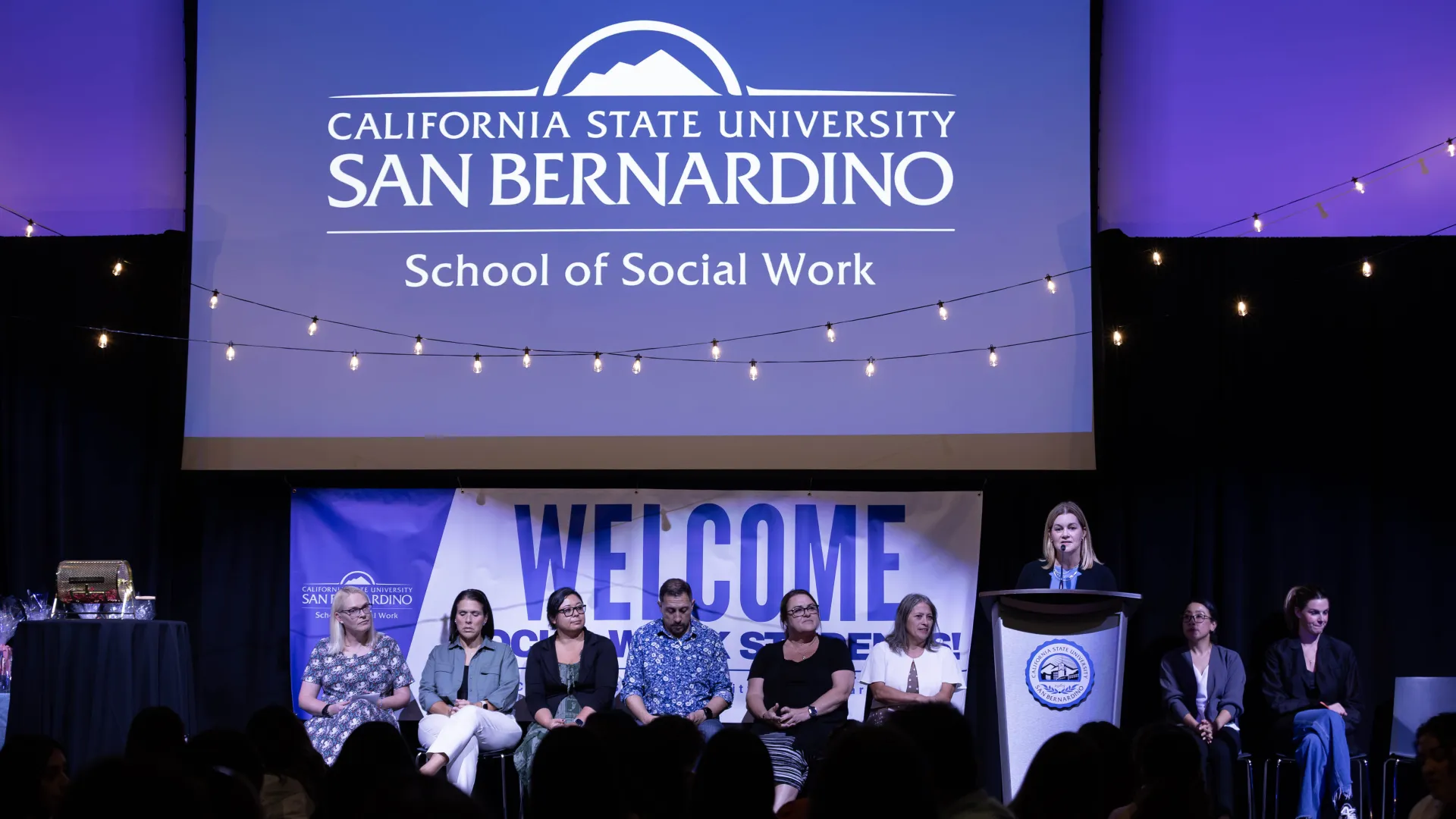Speakers on the stage during New Student Orientation Dinner at the Santos Manuel Student Union North Conference Center.