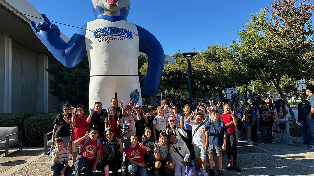 Students in front of an inflatable Cody Coyote.