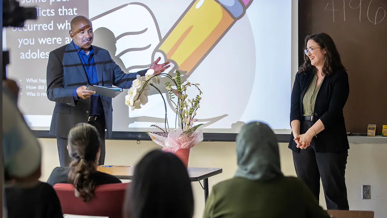 Rafik Mohamed, left, provost and vice president of Academic Affairs, presented Stacy Morris, assistant professor of child, adolescent, and family studies, with the 2025-26 Outstanding Faculty Advisor Award on April 23 for her dedication to CSUSB students and impactful advising. 