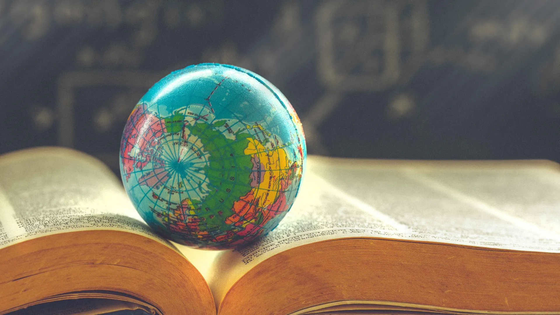 Small globe on an open book.