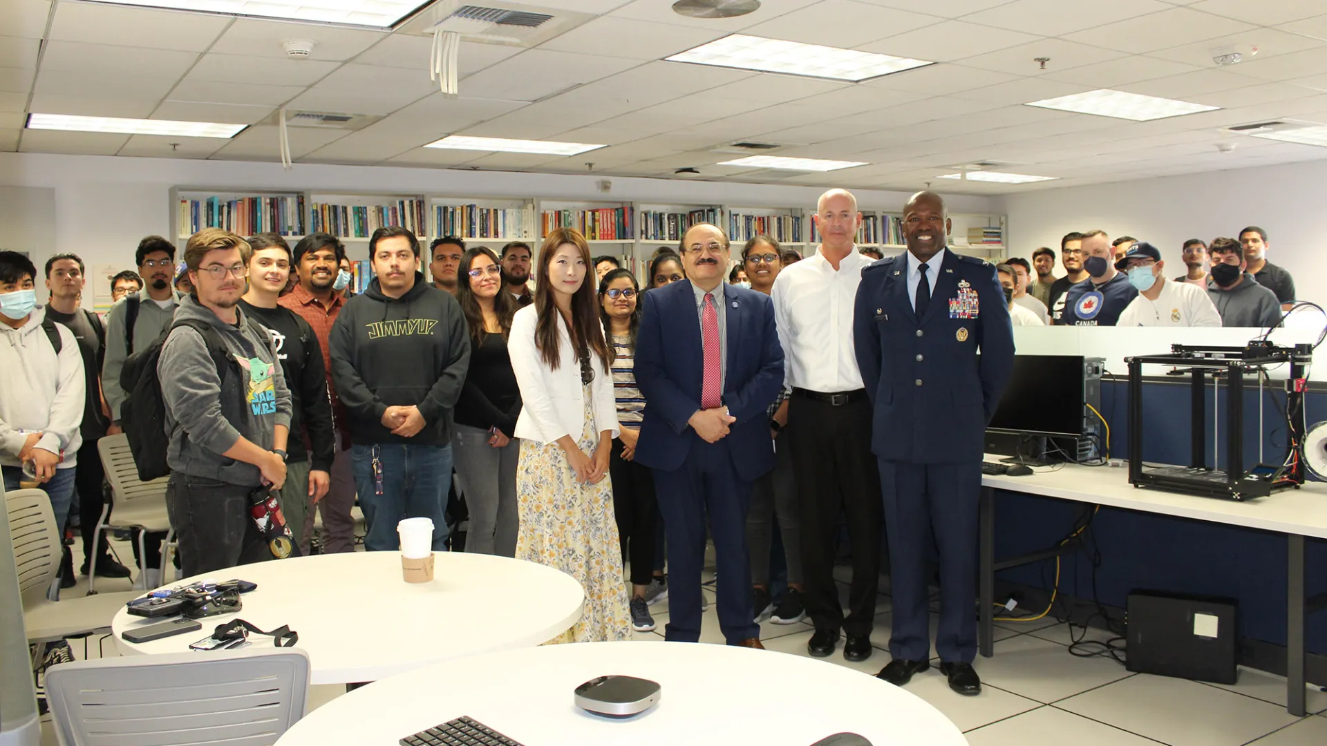 Beginning at center left, Jennifer Jin (in the white jacket), assistant professor, School of Computer Science and Engineering; Khalil Dajani, director and professor, School of Computer Science and Engineering; Stephan Ewart, U.S. Air Force Head of Engineering Squadron; Air Force Col. Ahave Brown Jr., commander of 412 MXG Squadron; with students who attended an Oct. 26 event at CSUSB.