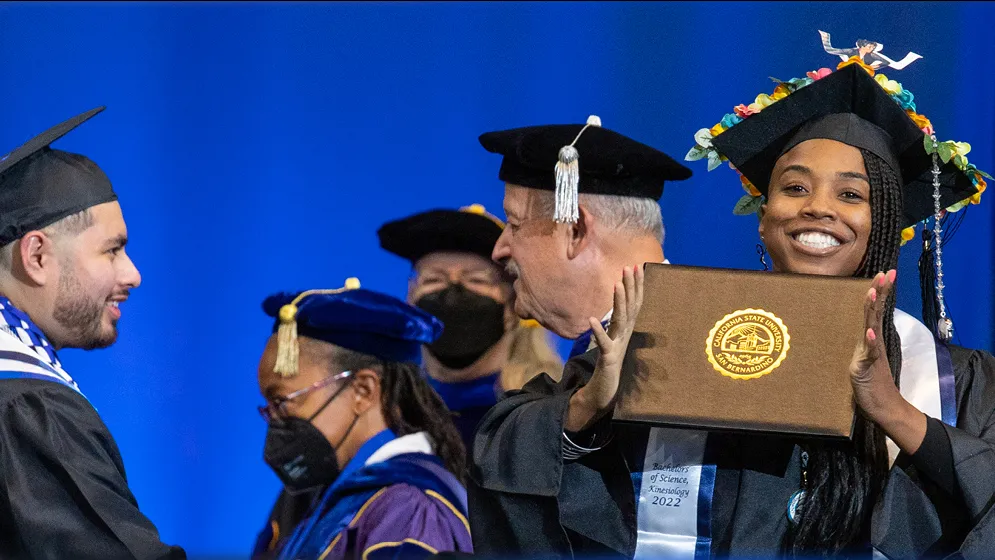 Photo of a graduate celebrating