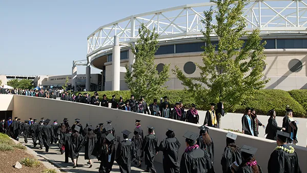 Graduates walking to commencement
