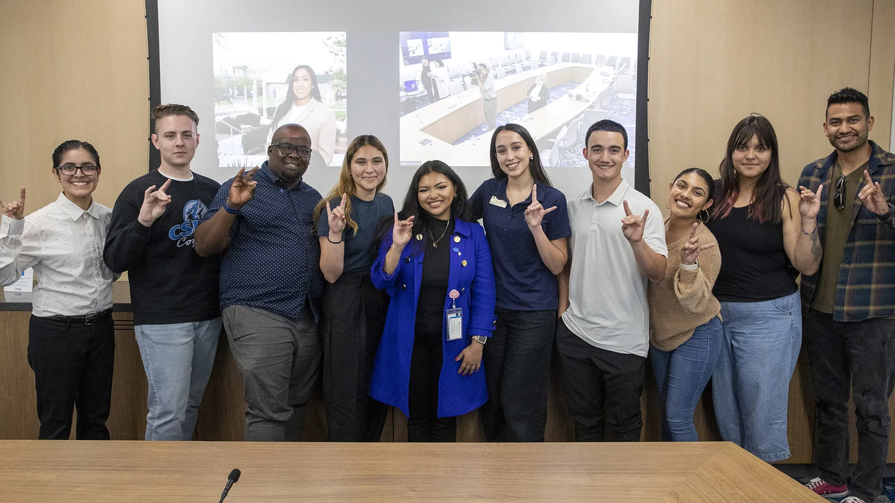 CSU Student Trustee Diana Aguilar-Cruz, center, in blue coat, shares some Coyote Pride with CSUSB ASI officers.