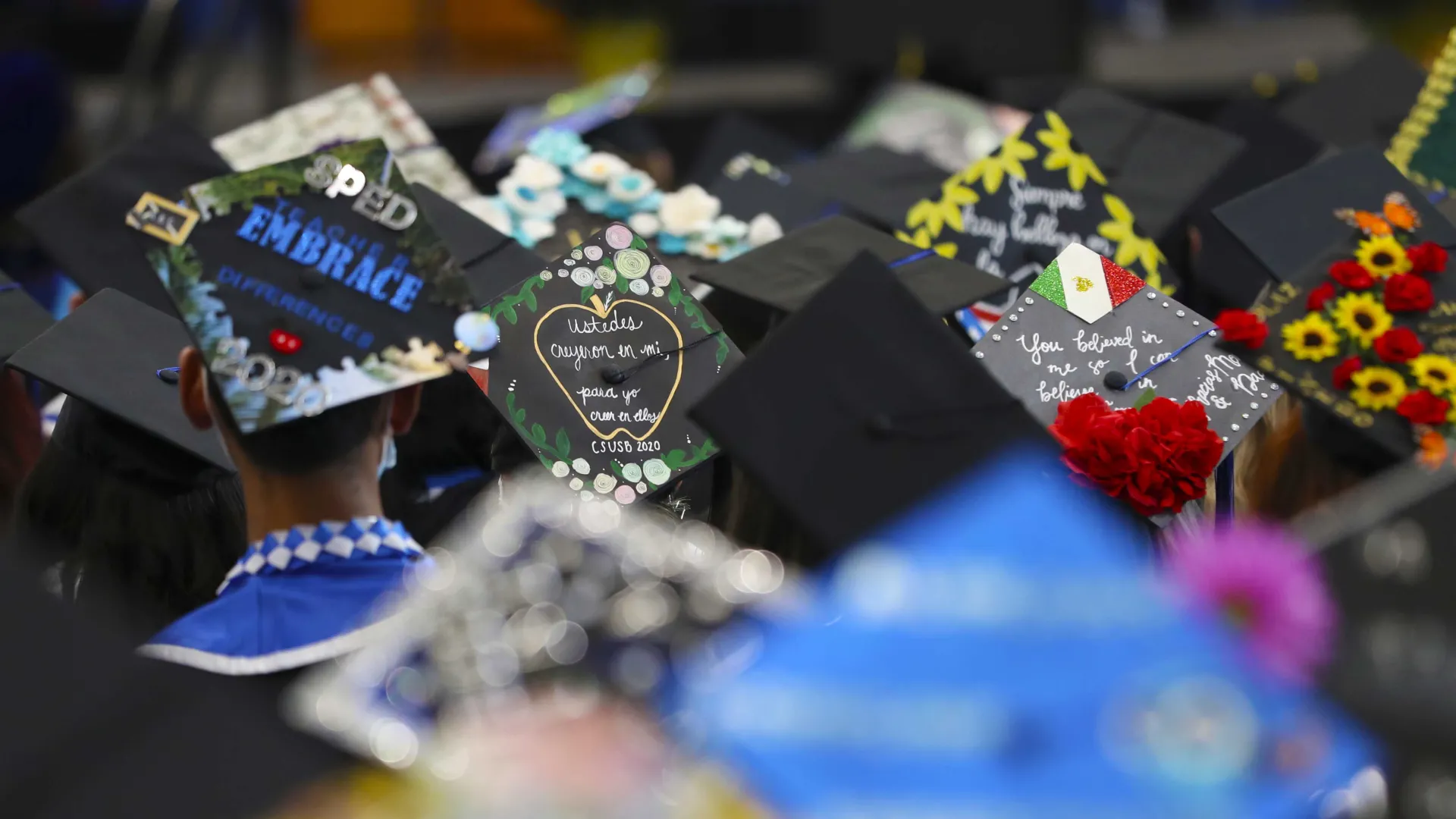 Graduates express their accomplishments on their mortar boards.