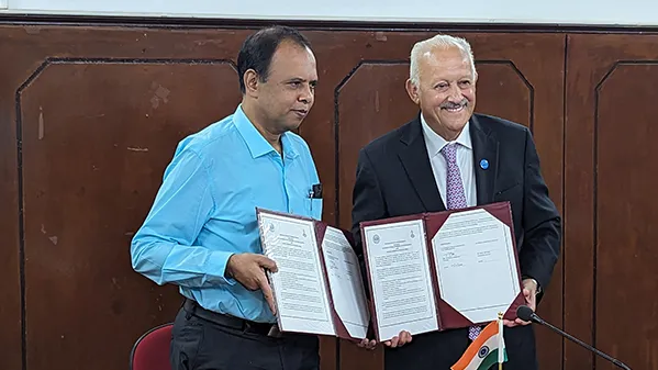 From left, R. Sridhar, vice principal of Madras Christian College's principal, and Tomás D. Morales, president of CSUSB, hold signed copies of a memorandum of understanding for academic exchange between the two higher education institution.