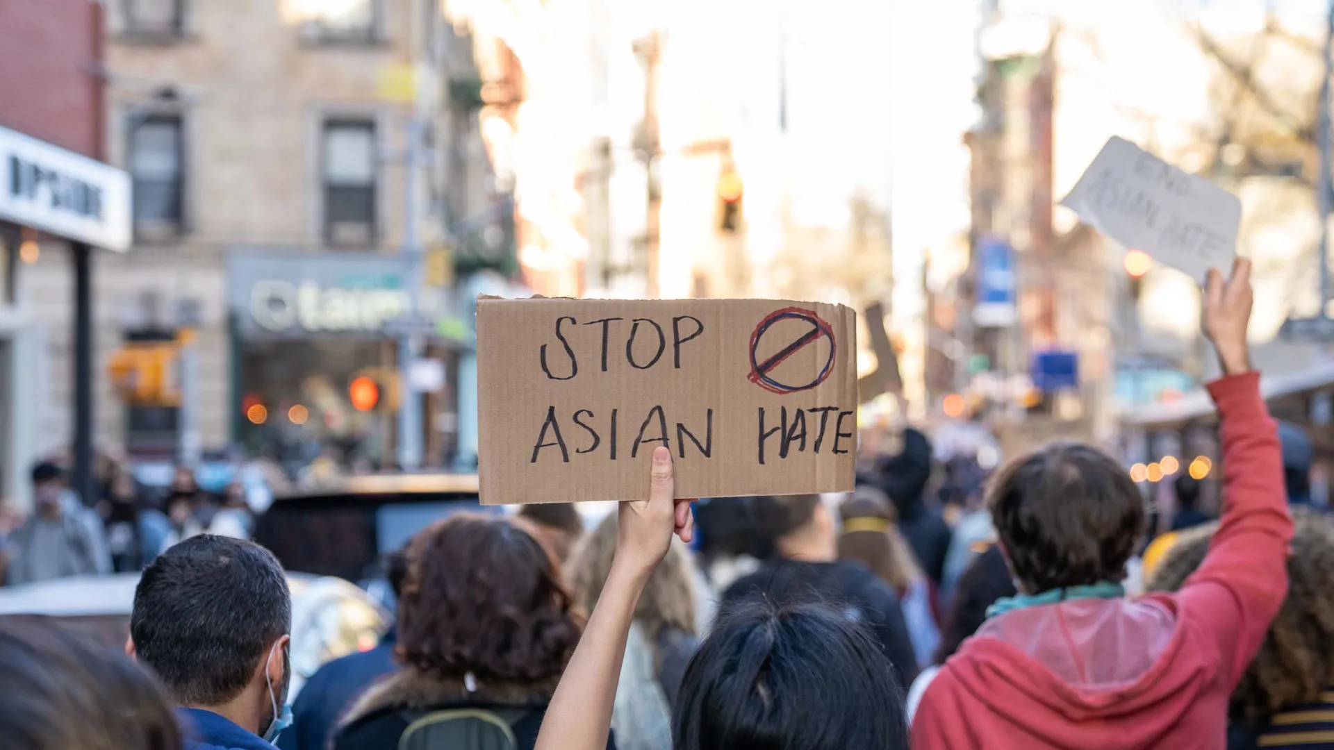 A sign held up at a rally protesting anti-Asian hate.