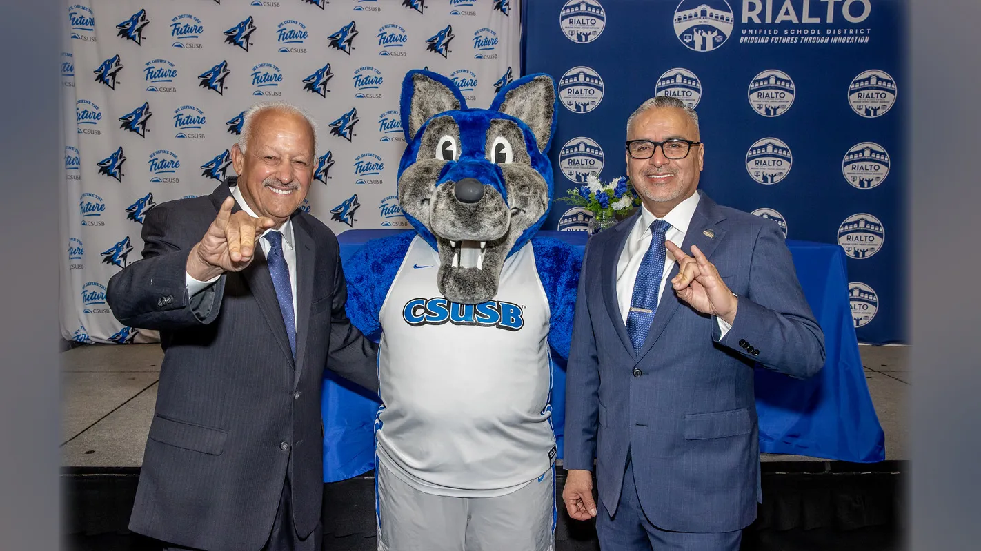 From left, CSUSB President Tomás D. Morales, CSUSB mascot Cody the Coyote, and Rialto Unified School District Superintendent Cuauhtémoc Avila. CSUSB and RUSD formally signed a memorandum of understanding that launched Teach Rialto.