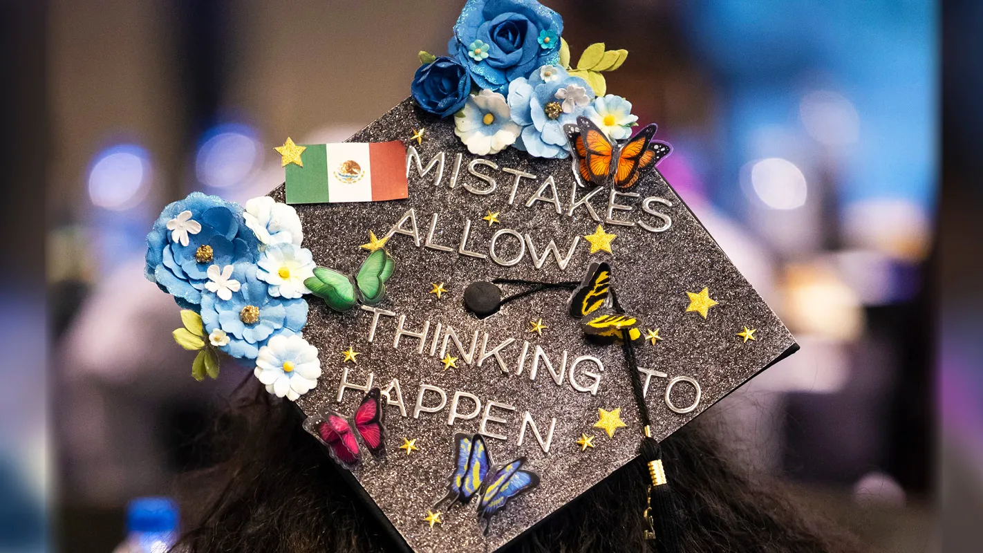 A decorated graduation cap at commencement