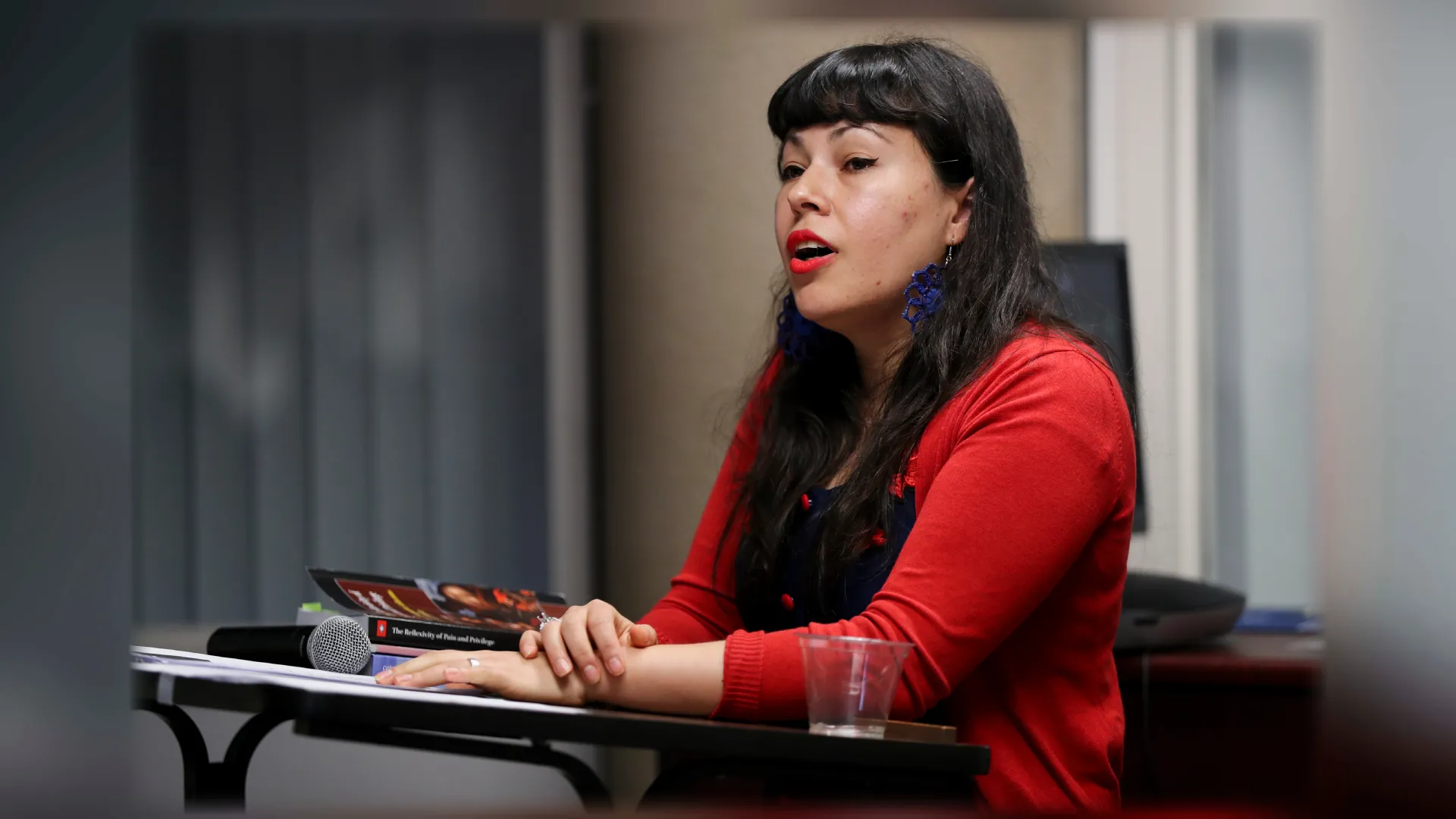 "Paloma Villegas, assistant professor of sociology speaking on a "A look back""