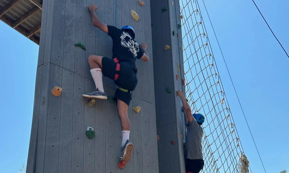 Students climbing a rock wall