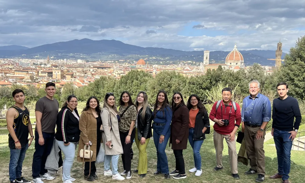 Several students posing in a field in Italy