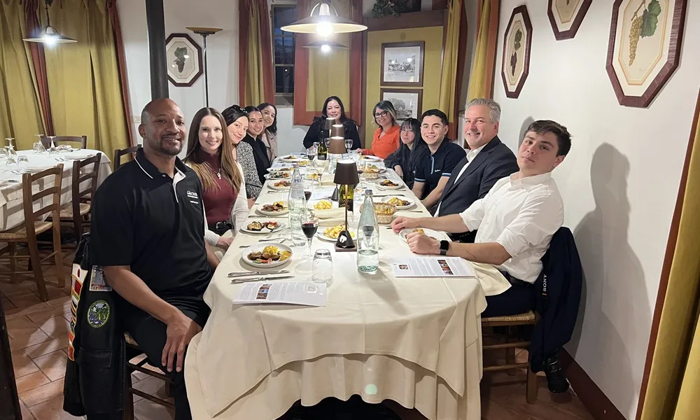 Students sitting around a table in italy