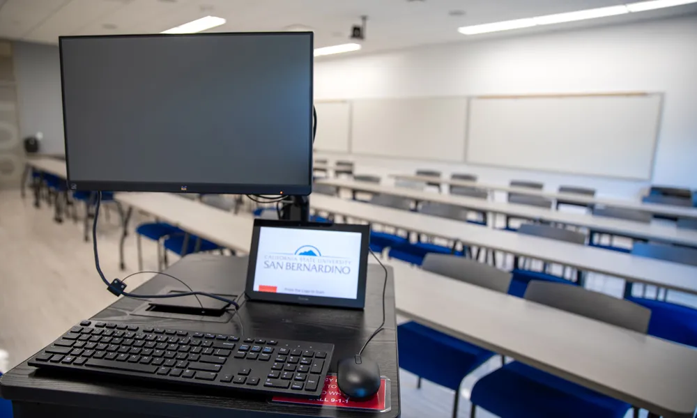A well-equipped meeting space featuring a large screen, video conferencing system, and high-speed internet connectivity.
