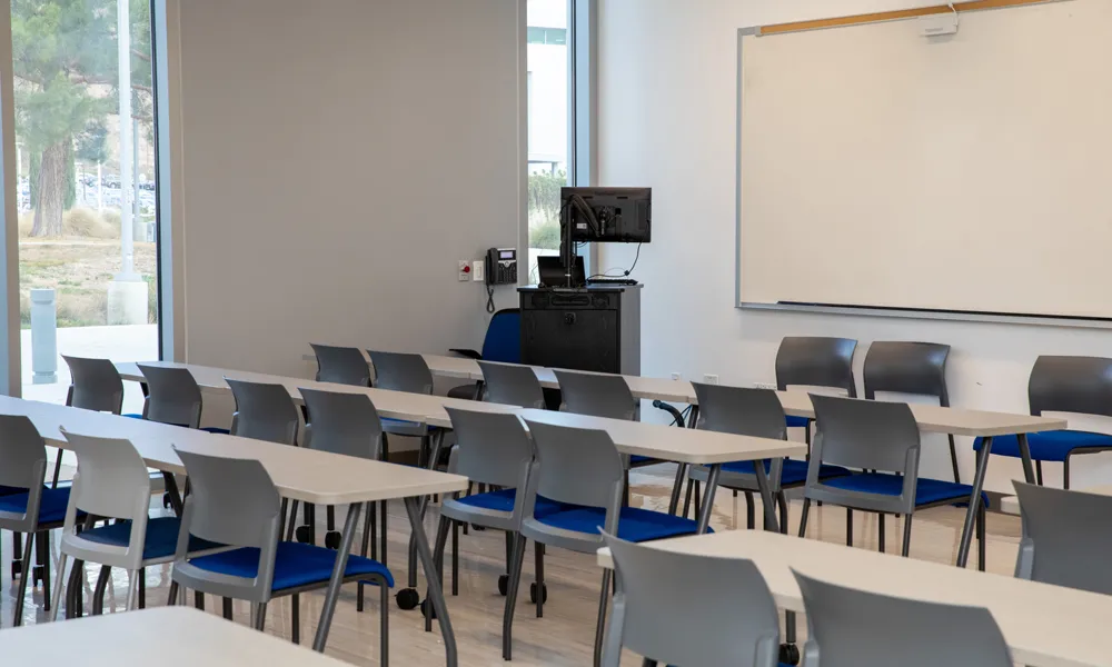An inviting collaboration area with seating, a whiteboard, and ample natural light.