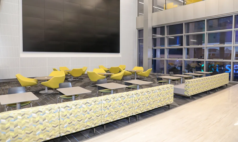 A side-angle view of a dynamic presentation space with sleek seating and cutting-edge media displays.