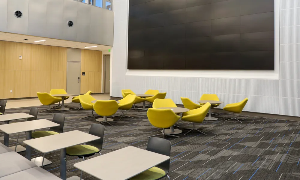 A side-angle shot showcasing the theatre-style seating and the modern presentation wall.