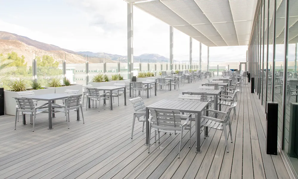 Open-air meeting area with comfortable seating, surrounded by mountain for a refreshing work environment.
