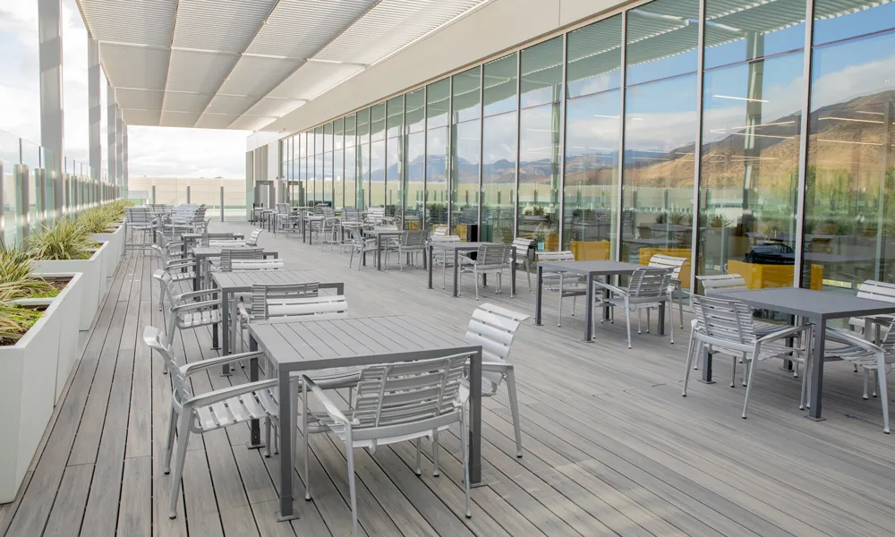 A wide-angle view of a contemporary outdoor terrace, set up for networking and social events.